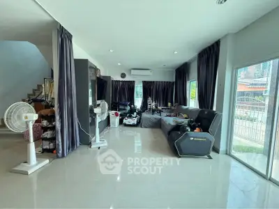 Spacious living room with modern decor and large windows for natural light