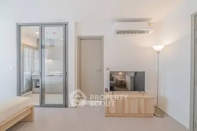 Modern minimalist bedroom with sliding glass doors and air conditioning