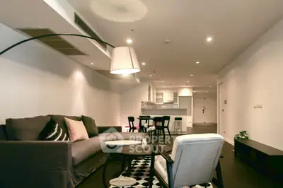 Modern living room with stylish furniture and open kitchen layout