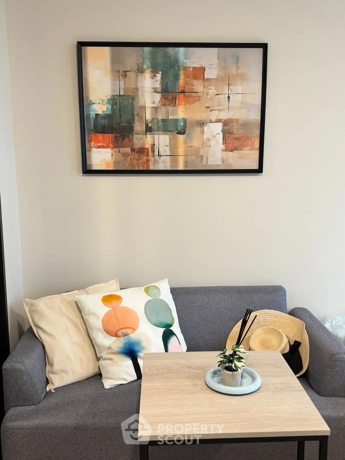 Cozy living room with modern art and stylish decor, perfect for relaxation.