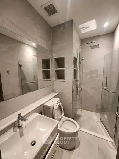 Modern bathroom with sleek fixtures and glass shower enclosure