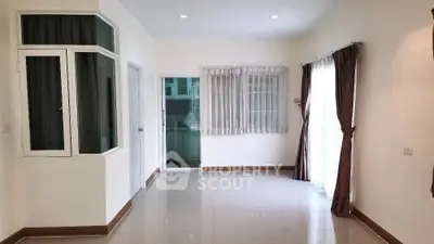 Spacious unfurnished room with large windows and glossy tiled floor