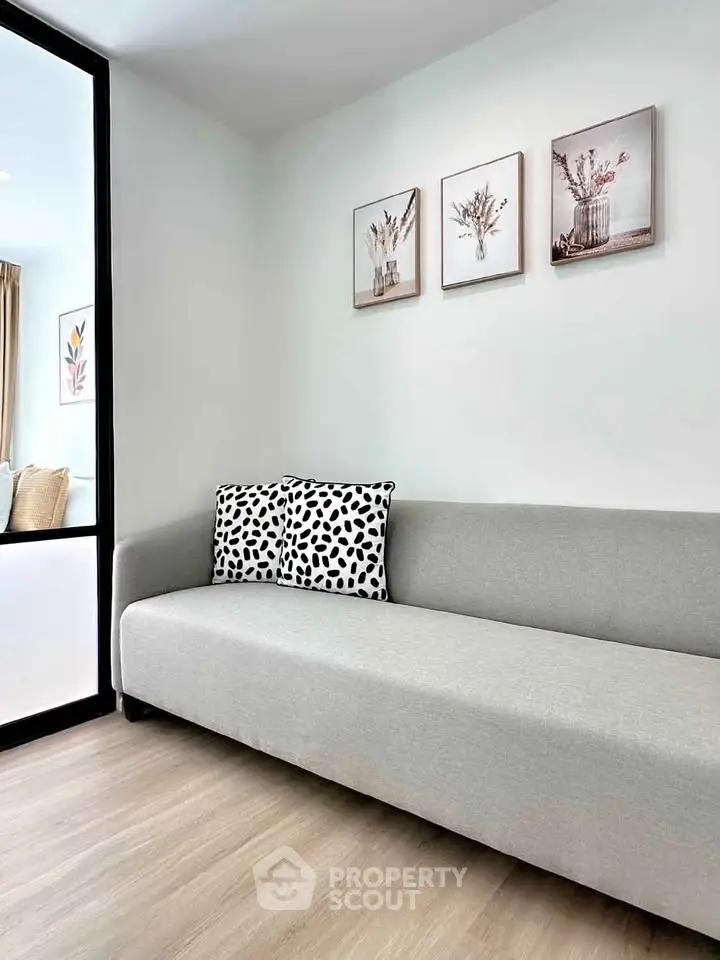 Modern living room with sleek gray sofa and stylish wall art
