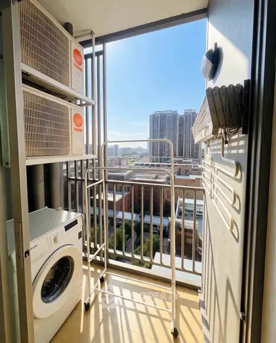 Charming balcony with laundry area and city view, perfect for urban living convenience.