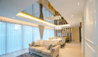 Luxurious modern living room with elegant dining area and plush furnishings