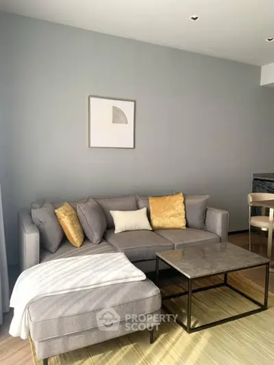 Stylish modern living room with cozy gray sofa and elegant decor