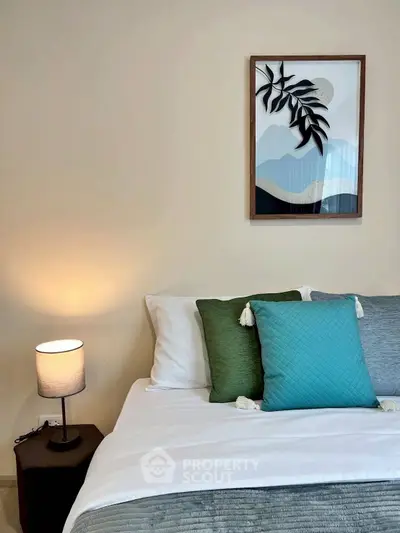 Cozy bedroom with stylish decor and modern artwork, perfect for relaxation and comfort.