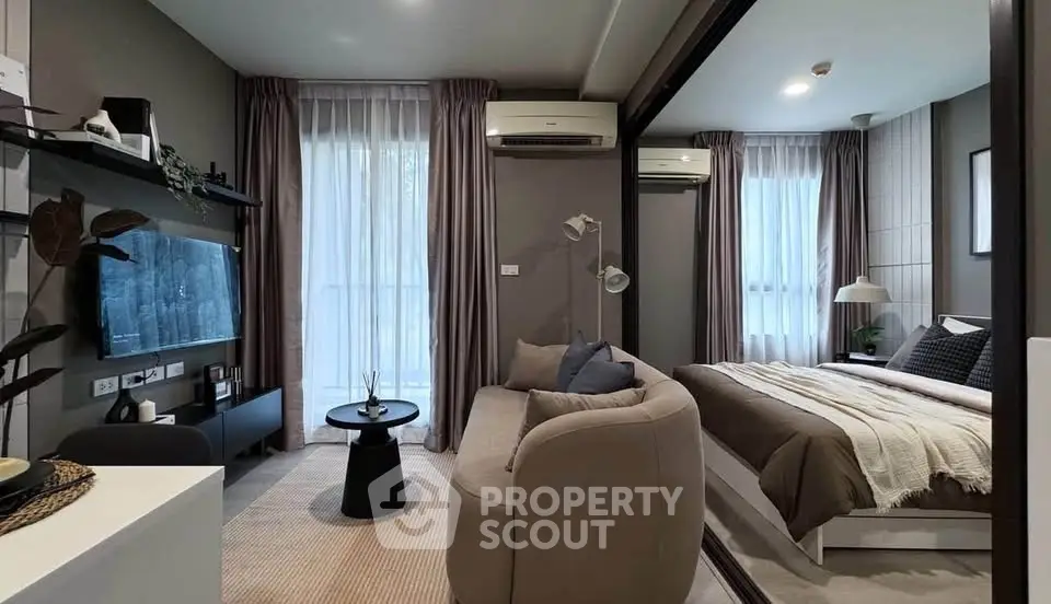 Modern studio apartment with cozy living area and stylish bedroom, featuring floor-to-ceiling windows and elegant decor.