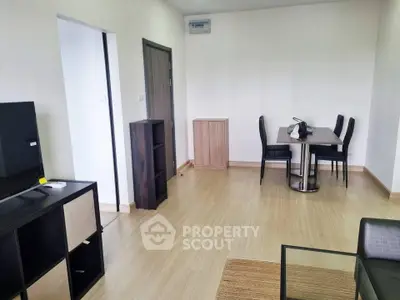 Modern living room with sleek furniture and dining area, perfect for urban living.