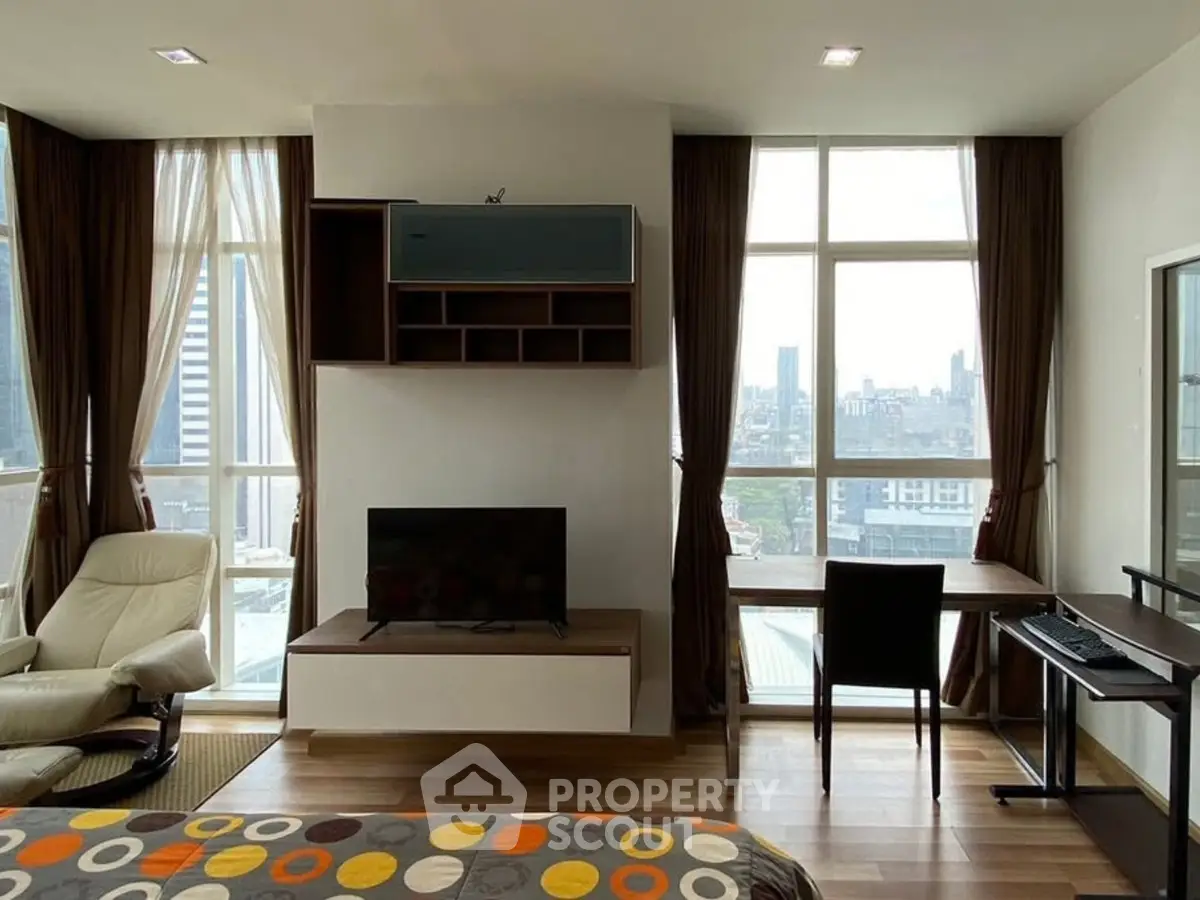 Modern studio apartment with city view, featuring cozy living area and workspace.
