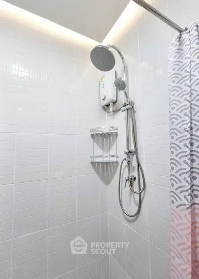 Modern bathroom shower with sleek white tiles and elegant showerhead