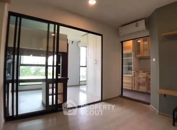 Modern apartment interior with glass partition and wooden flooring