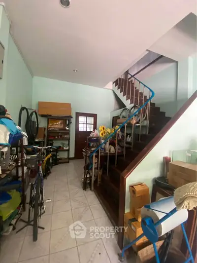 Spacious storage area with staircase and ample shelving in a residential property.