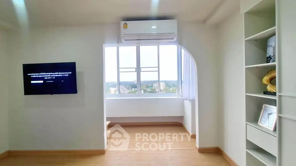 Bright living room with large window and modern decor