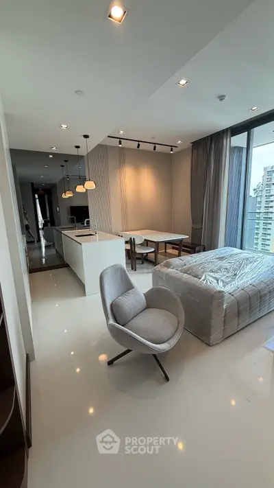 Modern open-plan living room with sleek kitchen and dining area, featuring floor-to-ceiling windows and contemporary furniture.