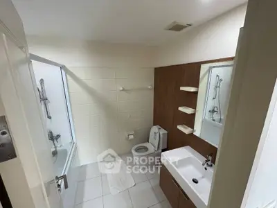 Modern bathroom with sleek fixtures and bathtub in contemporary apartment.