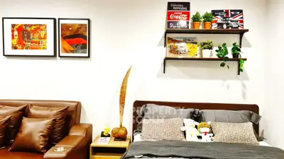 Stylish bedroom with cozy decor and modern art, perfect for relaxation.