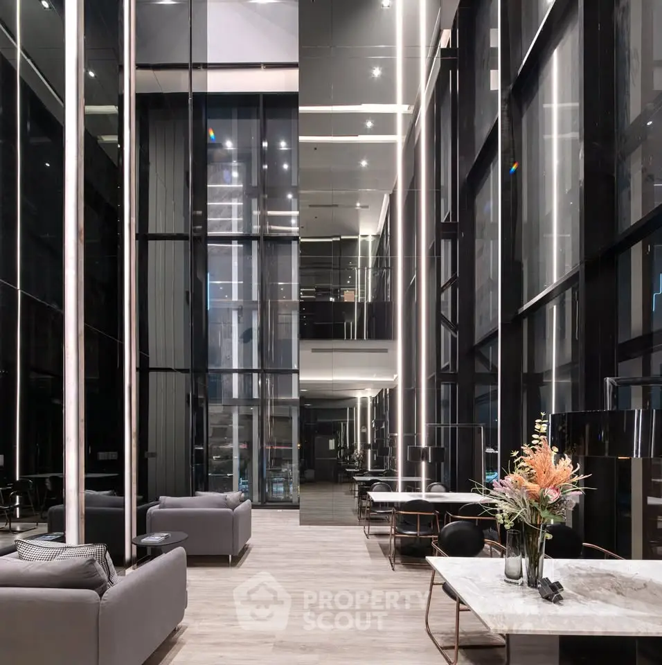 Luxurious modern building lobby with high ceilings and elegant seating area.