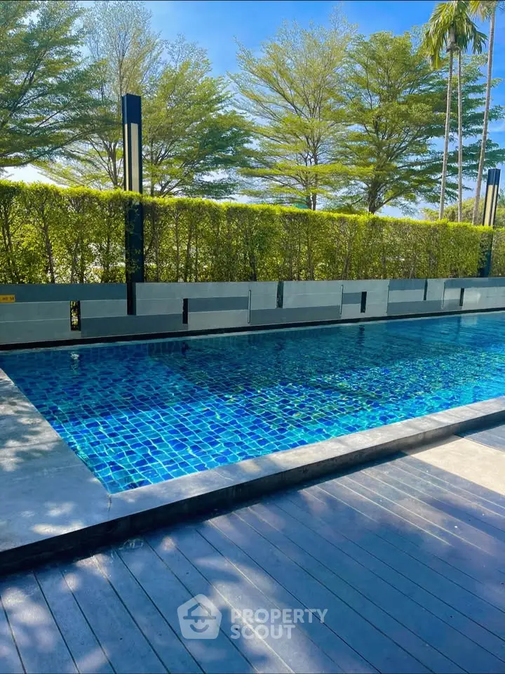 Luxurious outdoor pool with modern design and lush greenery