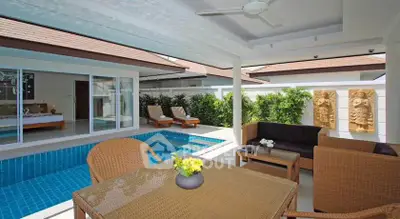 Luxurious villa with private pool and stylish outdoor seating area, perfect for relaxation and entertainment.