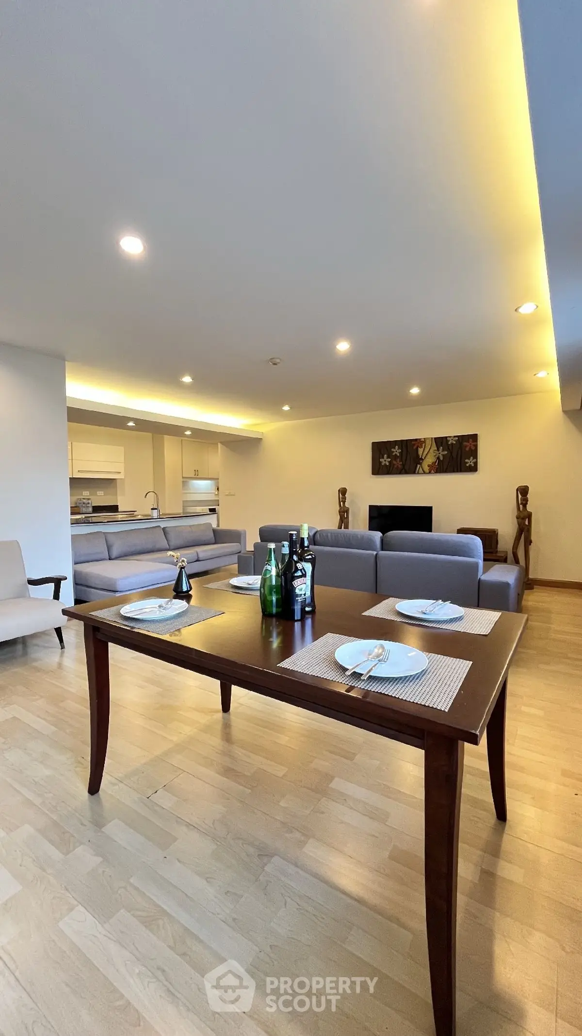 Spacious open-plan living and dining area with modern decor and ambient lighting.