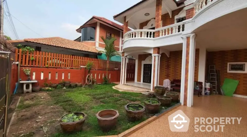 Charming two-story house with spacious garden and elegant balcony, perfect for family living.