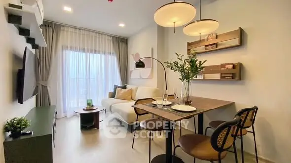 Modern living room with dining area, stylish decor, and large window view.