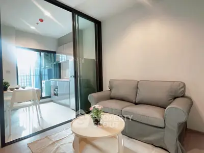 Modern living room with cozy sofa and open kitchen in stylish apartment