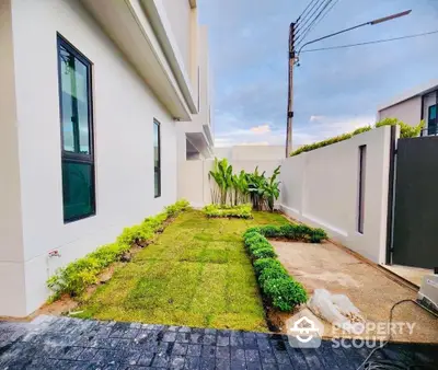 Modern townhouse with landscaped garden and sleek exterior design