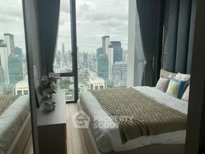 Luxurious bedroom with stunning city view from floor-to-ceiling windows.