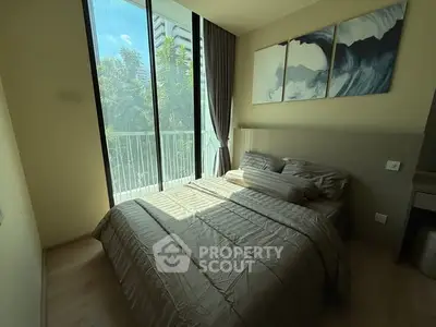 Modern bedroom with large windows and stylish decor in a high-rise apartment.