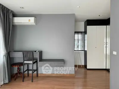 Modern minimalist bedroom with sleek furniture and ample natural light