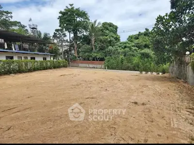 Expansive vacant lot ready for development, surrounded by lush greenery and established neighborhood, ideal for a custom dream home.