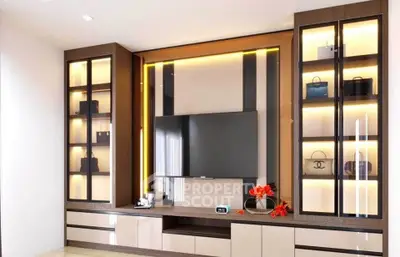 Modern living room with sleek TV unit and illuminated display shelves.
