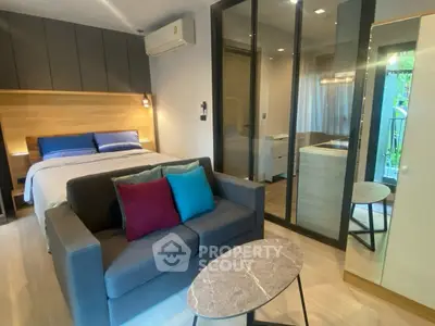 Modern studio apartment with cozy bed and stylish decor