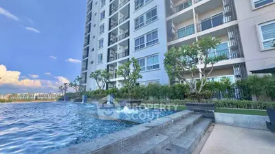 Luxurious condominium with stunning poolside view and modern architecture.