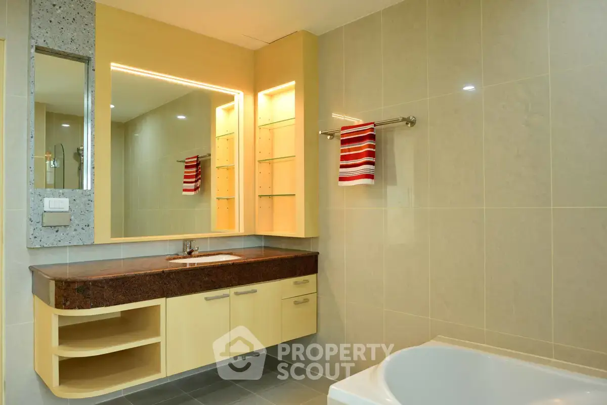 Modern bathroom with elegant vanity and bathtub in a stylish real estate property.