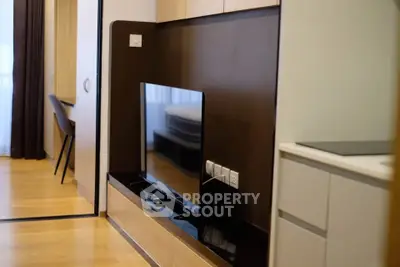 Modern living room with sleek TV setup and wooden flooring