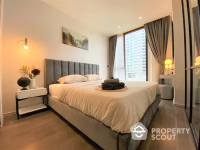 Elegant bedroom with plush king-sized bed, modern furnishings, and warm ambient lighting, perfect for a restful retreat in a stylish urban home.