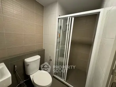 Modern bathroom with glass shower and sleek tile design