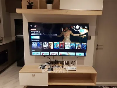 Modern living room with wall-mounted TV and sleek entertainment unit
