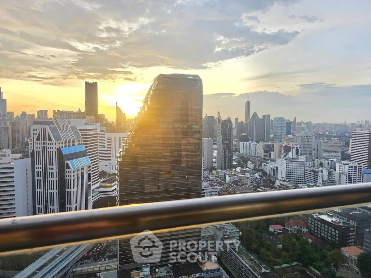 Stunning city skyline view from a high-rise balcony at sunset, showcasing modern architecture.