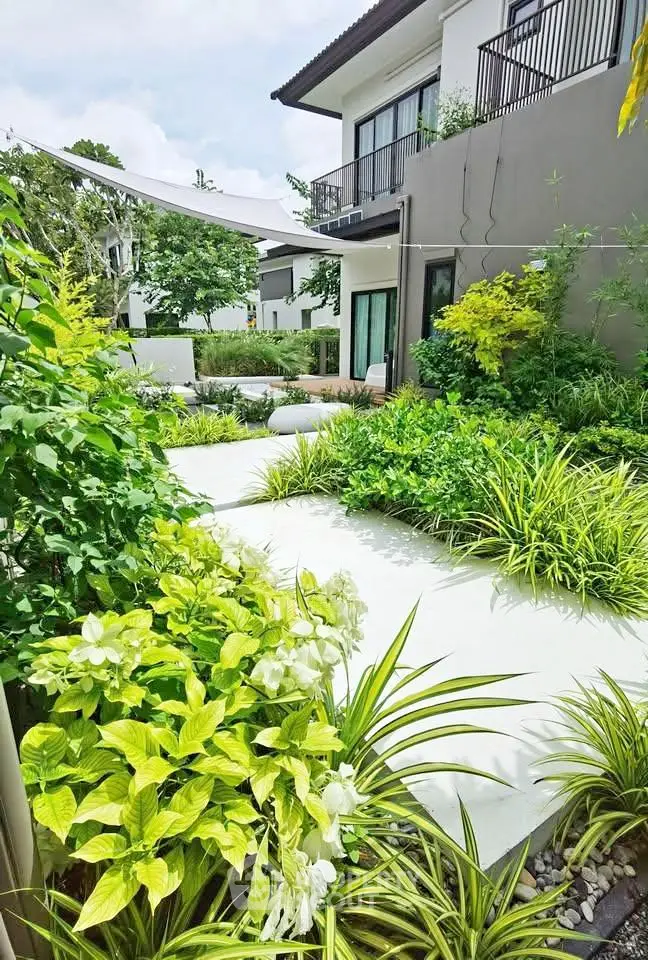 Luxurious modern home with lush garden and spacious balcony