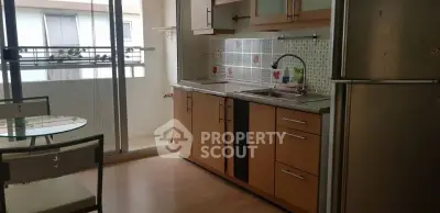Modern kitchen with balcony access, featuring sleek cabinets and stainless steel appliances.