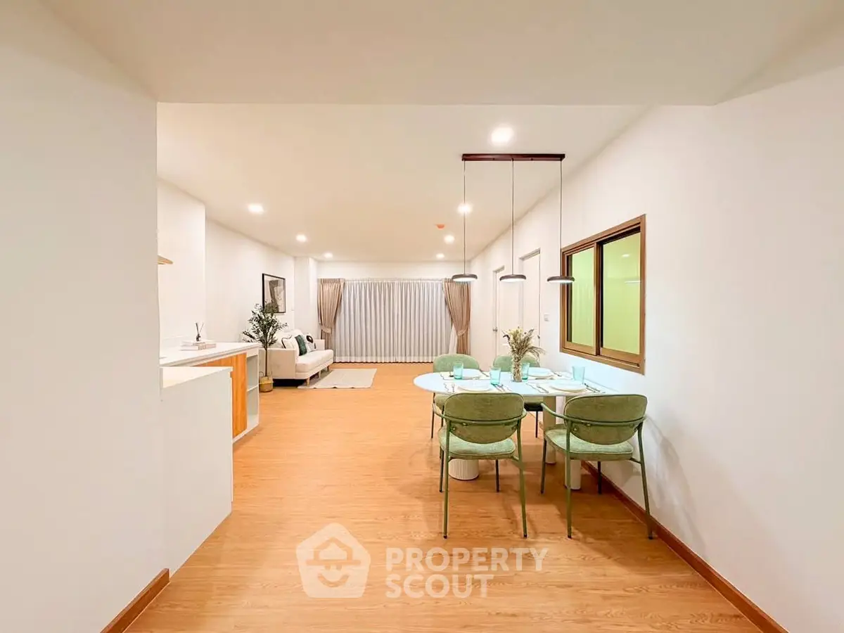 Spacious open-plan living and dining area with modern decor and natural light.