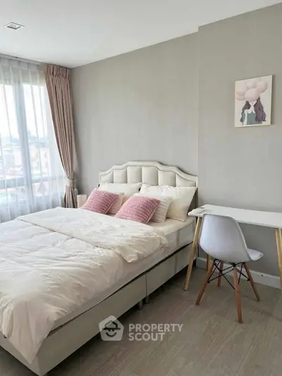 Cozy bedroom with stylish decor and natural light, perfect for relaxation and comfort.