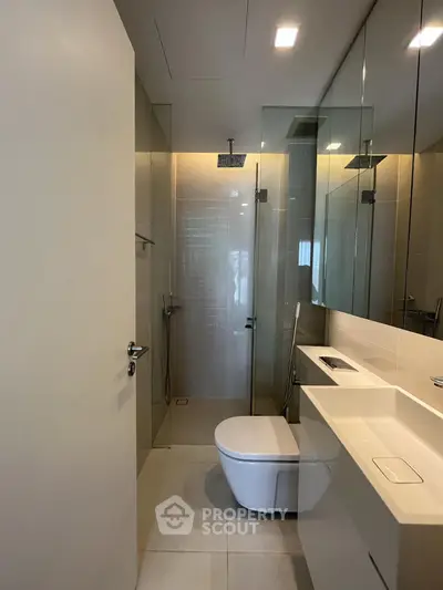 Modern bathroom with sleek fixtures and glass shower enclosure