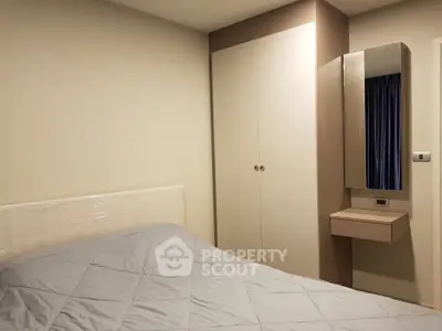 Cozy bedroom with modern wardrobe and stylish mirror in a contemporary apartment.