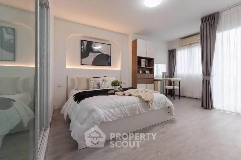 Modern bedroom with stylish decor, large windows, and elegant furnishings in a cozy apartment.