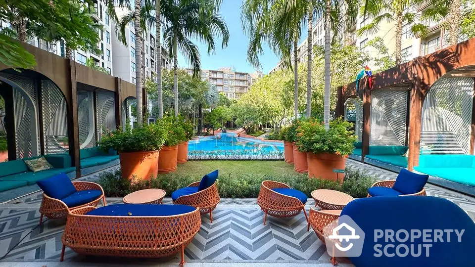 Luxurious garden view with modern outdoor seating and lush greenery in upscale residential complex.